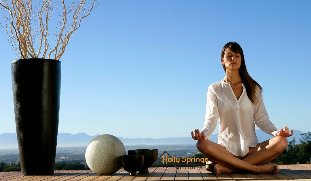Woman meditating on a Yoga and Meditation Deck with sky as the background - Holly Springs Builders
